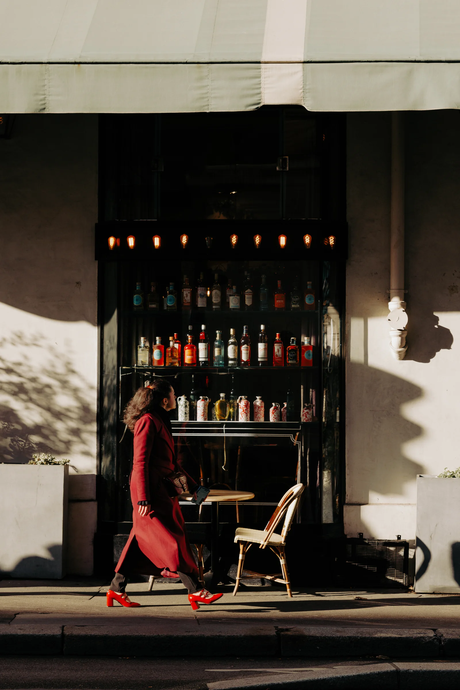 Red jacket at a Paris café, photographed by Campbell Jensen