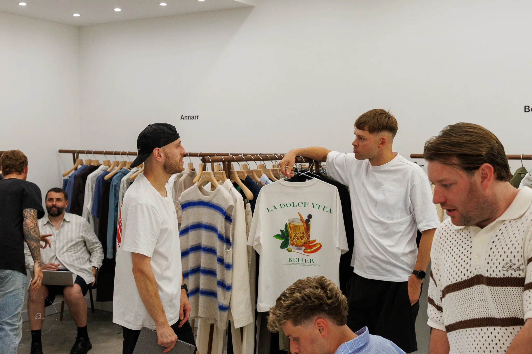 Guests talking over the collection at Good Place Showroom, Paris, photographed by Campbell Jensen