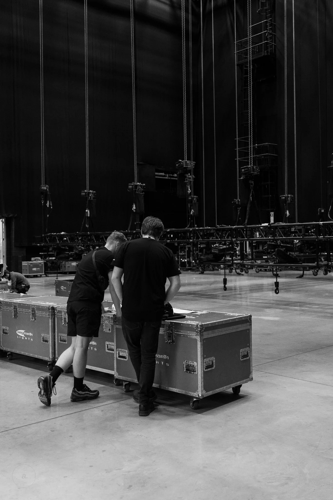 Crew moving flight cases across the warehouse floor, Neg Earth Lights, London, photographed by Campbell Jensen