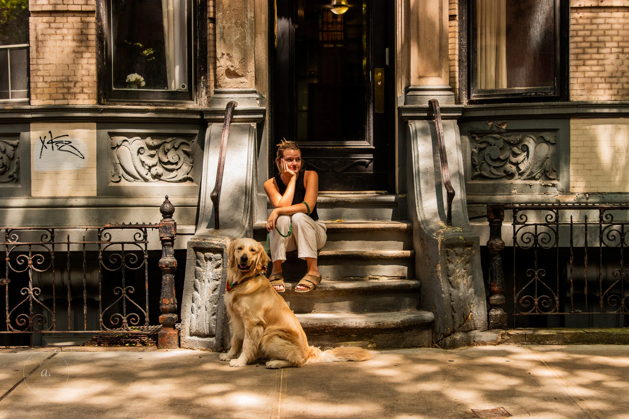 A woman and a golden retriever on the stoop of a brownstone, New York, photographed by Campbell Jensen