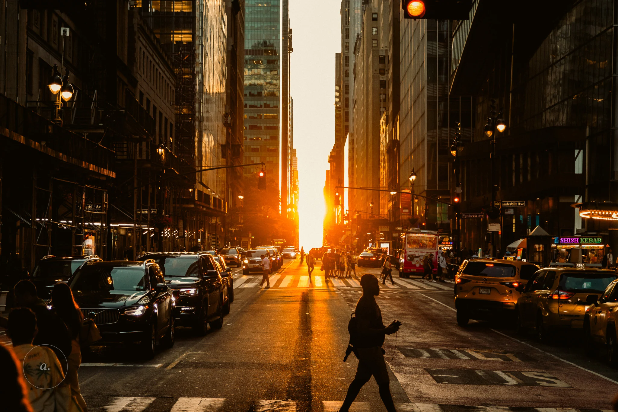 The setting sun aligned down a Manhattan cross street at Manhattanhenge, photographed by Campbell Jensen
